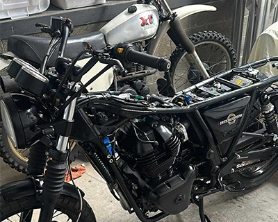 Two motorbikes mid-rebuild in the garage.